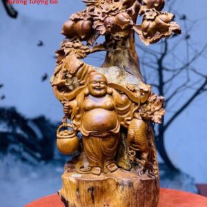 Di Lặc Gánh Gậy Đứng cây Đào